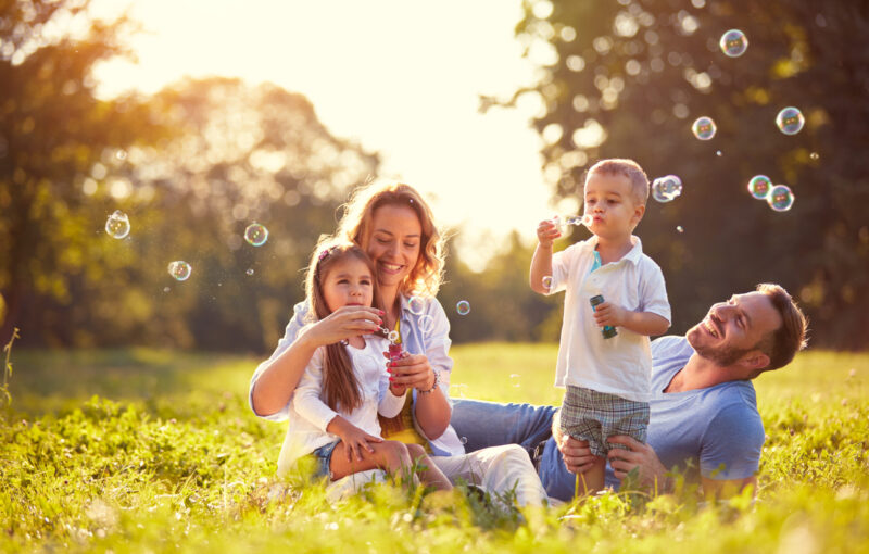 Family,With,Children,Blow,Soap,Bubbles,Outdoor